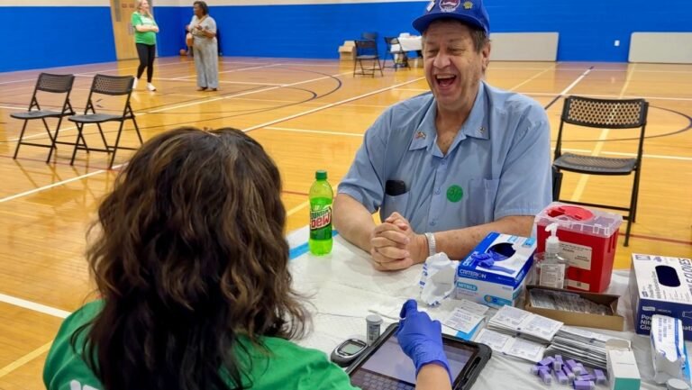 Edward Mueller smiles as he undergoes part of a kidney health screening at the YMCA in Blue Ash.